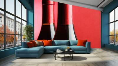 Two corked wine bottles over red background Wall mural