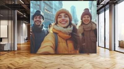 Smiling woman taking a selfie with friends in a city Wall mural