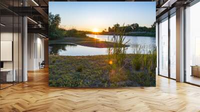 Sunset with sunbeams on the river Wall mural