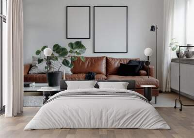 Two blank vertical din A posters with black frames in light room interior design. Frame mockups on a white wall, scandinavian style living room, brown leather sofa, coffee table, lamp, potted plants Wall mural