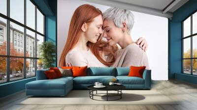 Two caucasian cool generation z women lgbtq lesbian couple dating in love hugging enjoying intimate tender sensual moment together feeling love isolated on white background. Close up view Wall mural