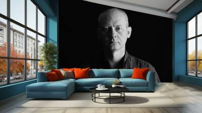 Portrait of serious man on dark background. Wall mural