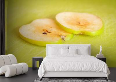 Two thin green apple slices on a cutting board turned brown due to the oxidation process close up stock image. Wall mural