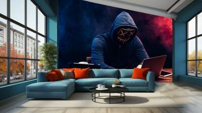 young criminal male hides his face under the hood and mask, hacks the password on the laptop, typing something. anonymous, incognito guy going to hack. cyberattack concept Wall mural