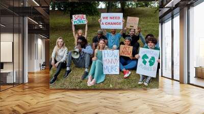 young diverse people protest with placards and posters on global strike for climate change. save our planet from plastic pollution Wall mural