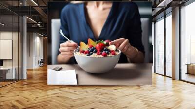 female office worker eating oatmeal granola with fruit and berries for lunch or breakfast, a white bowl. Generative AI technology Wall mural