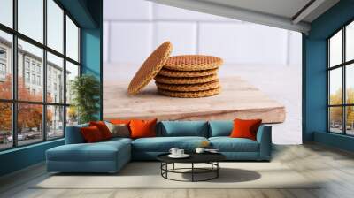 Stroopwafel - traditional dutch sirup waffles with caramel filling - stacked on top of each other on a wooden board, white kitchen Wall mural