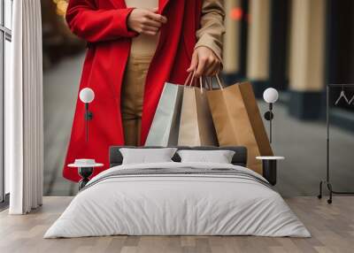 woman in colorful autumn clothes on a shopping spree in the city holding several paper bags Wall mural