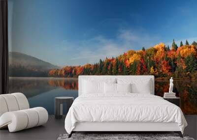 Autumn forest reflected in water. Colorful autumn morning in the mountains. Colourful autumn morning in mountain lake. Colorful autumn landscape. Autumn in Canada. Wall mural