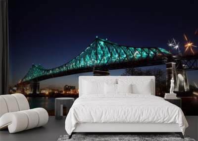 Jacques Cartier Bridge Illumination in Montreal, reflection in water. Montreal’s 375th anniversary. luminous colorful interactive Jacques Cartier Bridge. Bridge panoramic colorful silhouette by night. Wall mural