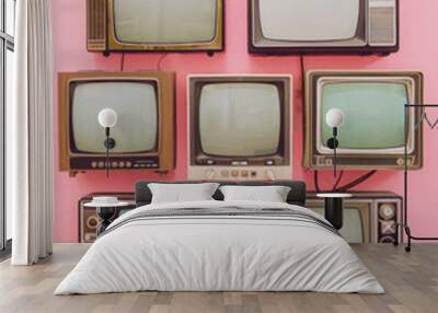 Six retro televisions in various colors arranged on pink background. Flat lay composition for design and print Wall mural