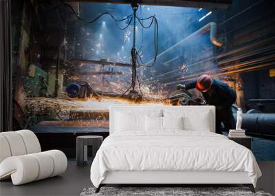 Employee grinding steel with sparks - focus on grinder. Steel factory. Wall mural