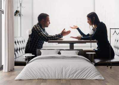 Man and woman in discussions in the restaurant Wall mural