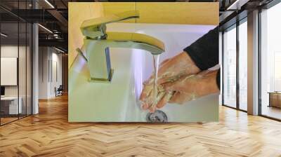 Coronavirus prevention hand hygiene. Corona Virus pandemic protection by cleaning hands frequently. COVID-19. Coronavirus prevention washing hands with soap at bathroom sink man hand hygiene for Wall mural