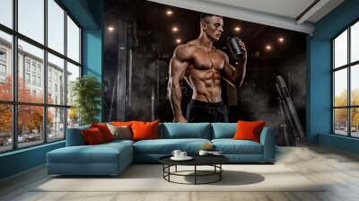 Muscular Man Resting After Exercise And Drinking From Shaker Wall mural