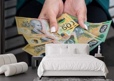 business woman count new 50 100 AUD Australian dollar bills,  showing money. Concept of economy Wall mural