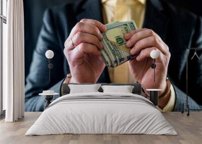 composition of the hands of a business man with money in his hands and handcuffs on them. Wall mural