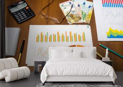 financial concept - graphics with calculator, pen,  money on table Wall mural