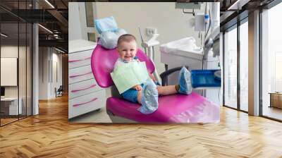 Little boy in dentistry, sitting in chair Wall mural