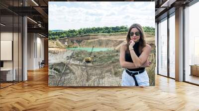 Portrait beautiful caucasian woman in the green field in summer time Wall mural