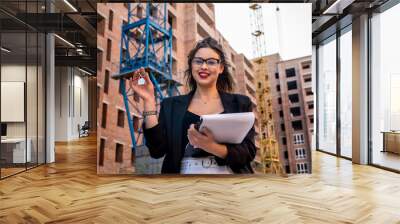 portrait of a realtor woman standing in front of a new house Wall mural