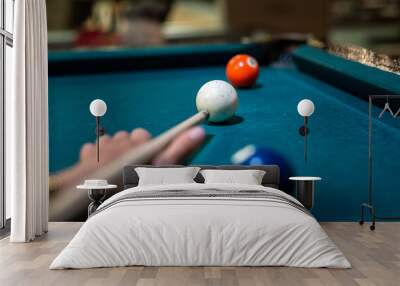 woman playing billiard, close up of player take a shot Wall mural