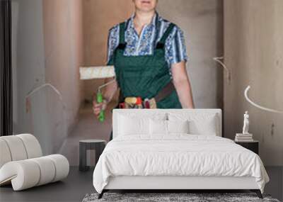 Woman posing with roller and bucket for painting Wall mural