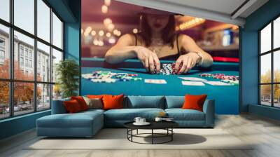 young woman in black dress win In Blackjack game and rejoicing to all chips after poker game Wall mural