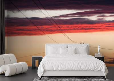 Electric line against colorful sky at sunset Wall mural