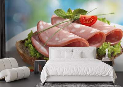 Sandwich with boiled sausages and lettuce leaves in white plate  on blurred background Wall mural