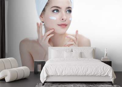 Skin care teenage girl putting face cream / photos of attractive girl on white background Wall mural