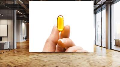 Women's fingers shows one capsule of omega 3 on white background. Copy space, high resolution product. Health care concept Wall mural