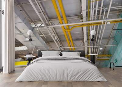 Ceiling with ventilation pipes and lights in industrial building Wall mural