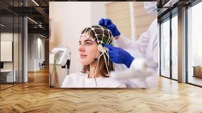 Patient brain testing using encephalography at medical center Wall mural