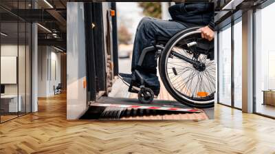 Person with a physical disability enters public transport with an accessible ramp. Wall mural