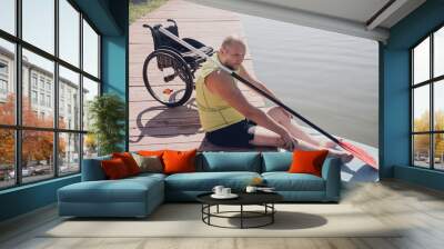 Person with a physical disability who uses wheelchair will be ride on sup board Wall mural