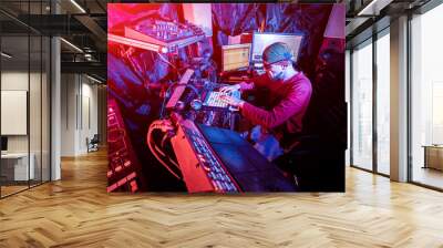 Sound engineer working at mixing panel in the in sound recording studio. Wall mural