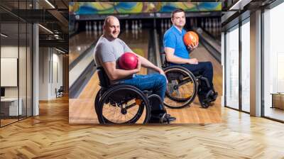 Two young disabled men in wheelchairs playing bowling in the club Wall mural