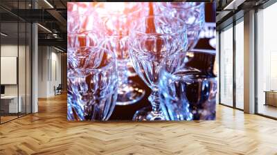 Wine and martini glasses in shelf above a bar rack in restaurant.  Wall mural