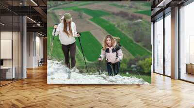 2 friends go on an easy hike in the mountains. Beautiful ladies rest in nature. 
Friendship between girls. Trekking cliffs. Travel, traveler
 Wall mural