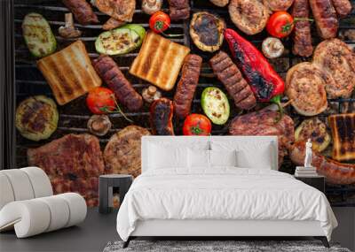 A large variety of grilled meat on the fire outside. Picnic with meat: sausages, pork steak, chicken breast with vegetables.  Wall mural