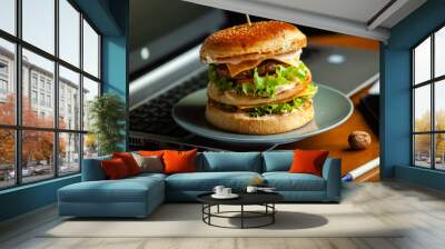 Eating at work place - fast food. burger near laptop. lunch break while you work or sharing online Wall mural