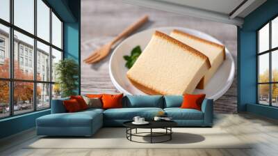 Castella (kasutera) - Delicious Japanese sliced sponge cake food on white plate over rustic wooden table, close up, healthy eating, copy space design. Wall mural