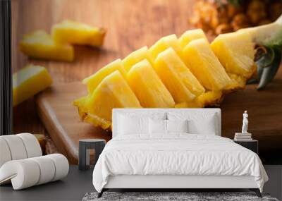 Fresh cut pineapple on a tray over dark wooden table background. Wall mural