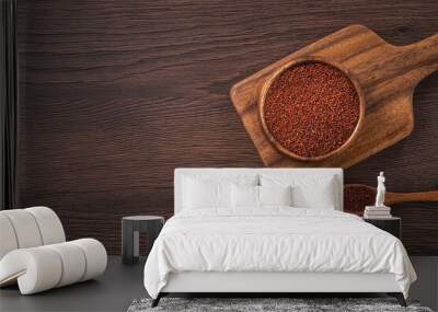 Organic red quinoa in a bowl on wooden table background. Wall mural