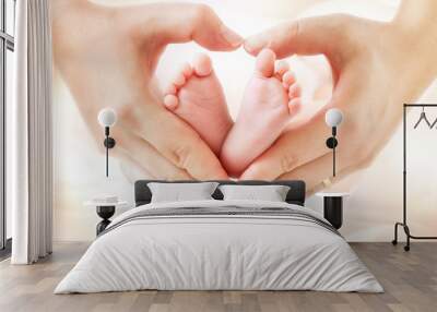 baby feet in mother hands - hearth shape Wall mural