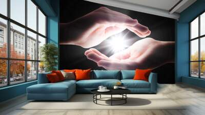 cross light in the darkness in your hands Wall mural