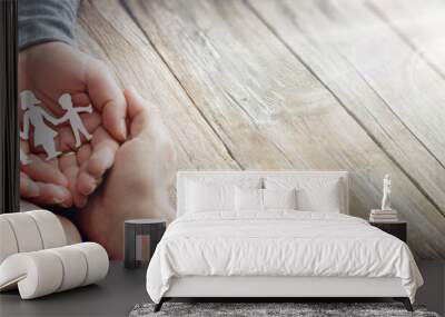 Family Care - Hands With Paper Silhouette On Table Wall mural