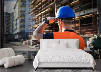 A man construction worker on building site. Wall mural