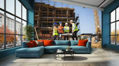 Four construction workers having meeting,stock photo Wall mural